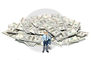 Investment advice concept. A businessman standing in front of paper cash money pile