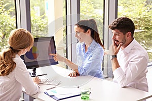 Investment advisor businesswoman giving savings ideas to young couple