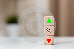 Investment market risk up or down concept. wooden cube block with percentage arrow high to low symbol icon