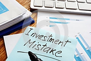 Investment Mistake written on financial documents photo