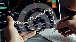 Investment stockbroker stock market analysis data graph on smartphone