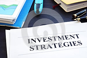 Investment strategies and folder with business documents.