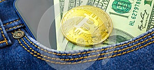 Investment and trading banner background with golden bitcoin close-up, crypto currency in a pocket of blue jeans, US