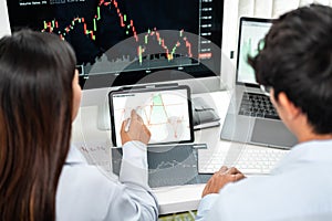 Investor business team working with computer, tablet and analyzing graph stock market trading planning with chart data financial