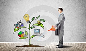Investor watering drawing tree with symbols