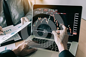 Investors are pointing to laptops that have investment information stock markets and partners taking notes and analyzing
