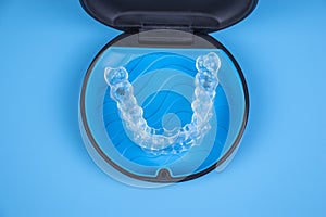 Invisalign transparent braces in a plastic case. Orthodontic invisible retainers and aligners photo