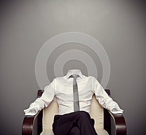 Invisible man sitting on armchair