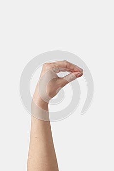 Invisible object holding female hand on white.