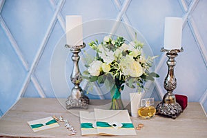 Invitation card on outdoor wedding table. bouquet of candles perfume