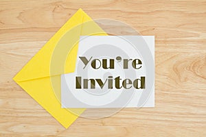 You`re invited message on wood table photo