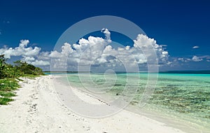 Inviting amazing natural landscape view of Cuban beach against deep blue sky and tranquil, turquoise ocean