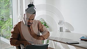 Involved student watching laptop workplace. Focused man looking screen at home