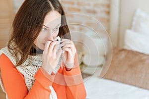 Involved young woman suffering from flu at home