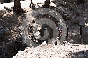 The Inyo Earthquake Fault in Mammoth Lakes California, female explores the area, showing the scale of the fault line