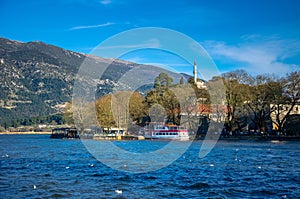 Ioannina city in Greece. View of the lake and the mosque of Aslan Pasa cami with seagulls and swans. photo