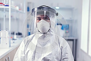 iochemistry scientist wearing face mask and face shield as safety precaution for covid19 photo