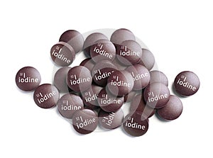 Iodine pills on white background, top view. Mineral element