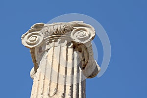 Ionic order column chapiter against blue sky