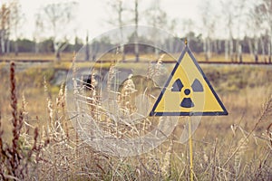 Ionizing Radiation sign next to Red Forest in Chernobyl Nuclear Power Plant Zone of Alienation, Ukraine