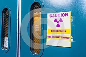 Ionizing radiation warning symbol displayed at the entrance to a laboratory; Message posted: