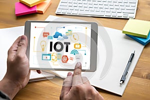 IOT business man hand working and internet of things (IoT) word