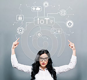 IoT security theme with business woman pointing upwards