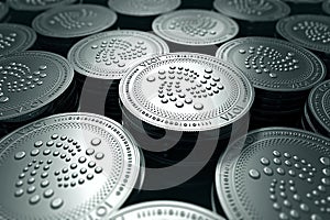 IOTA coins in blurry closeup. New cryptocurrency and modern banking concept. photo