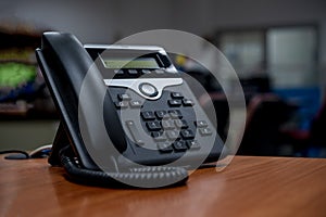 IP telephone on wood table, office workspace