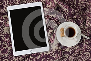 IPad Apple tablet with a cup of coffee. Elegant and cozy feminine background, concept for advertisement photo