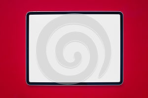 A iPad Pro with a white screen on a red background