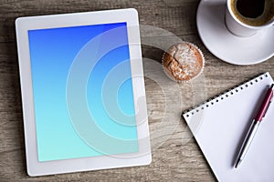 Ipad Tablet with cup of coffee over wooden table