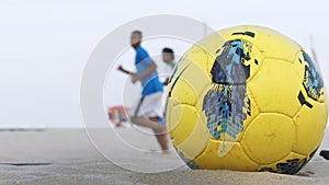 Ipanema beach, Rio de Janeiro, Brazil, silhouette of locals playing football at sunset.