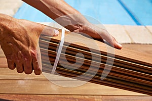 Ipe deck installation carpenter hands holding wood photo