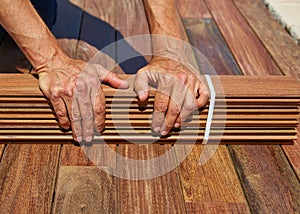 Ipe deck installation carpenter hands holding wood