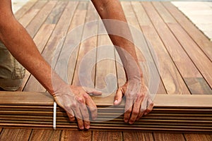 Ipe deck installation carpenter hands holding wood