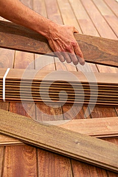 Ipe deck installation carpenter hands holding wood photo
