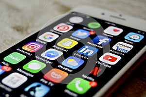 iPhone with assortment of apps displayed
