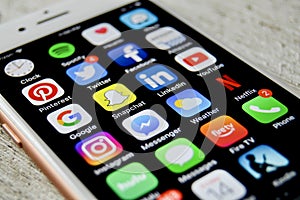 iPhone with assortment of apps displayed