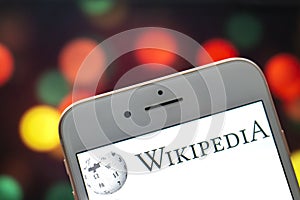 An iPhone Plus with a Wikipedia logo on the screen