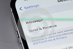 iPhone with settings iMessage on screen
