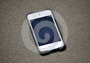 IPod in the sand background - photo