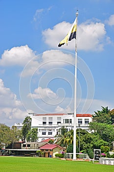 Ipoh High Court, locally called mahkamah tinggi ipoh white colonial building seen from the green field with Perak flag, Malaysia