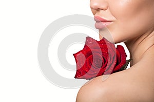 Ips, shoulder, part of the face of a woman. Red rose in her hands. Skin care concept. White background. the beauty