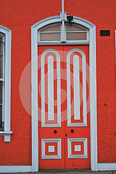 iquique chile, in front of a wooden house, door painted orange, historic year 1920