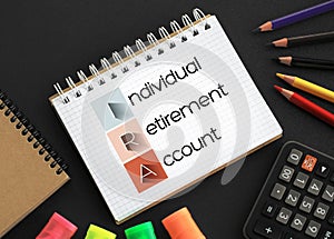 IRA - Individual Retirement Account acronym on notepad, concept background