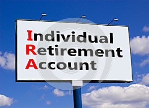 IRA individual retirement account symbol. Concept words IRA individual retirement account on billboard on a beautiful blu sky