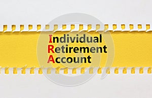 IRA individual retirement account symbol. Concept words IRA individual retirement account on yellow paper on beautiful white