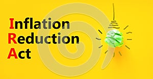 IRA inflation reduction act symbol. Concept words IRA inflation reduction act on yellow paper on beautiful yellow background.