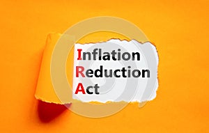 IRA inflation reduction act symbol. Concept words IRA inflation reduction act on white paper on a beautiful orange background. photo